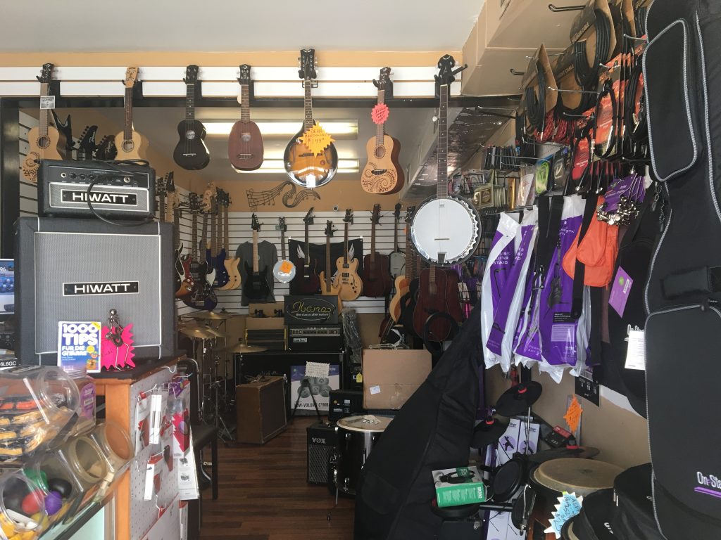 Inside of Beachwood Music, showing multiple instruments for sale.
